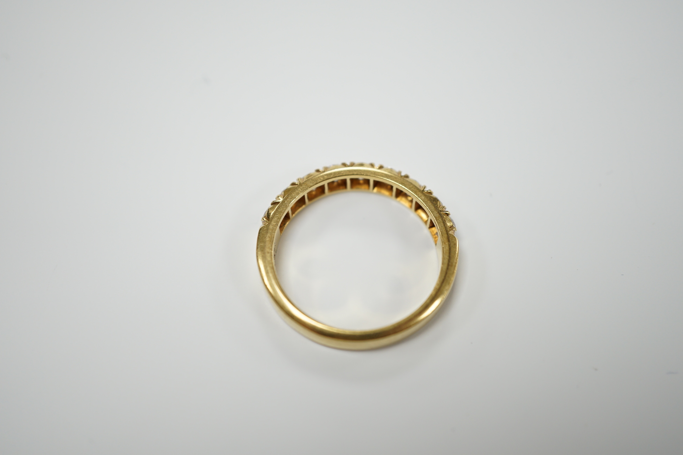 A modern 18ct gold and nine stone diamond set half hoop ring, size R/S, gross weight 6 grams.